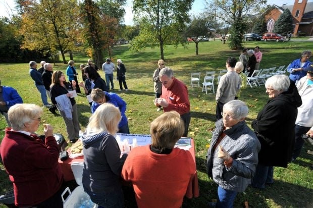 community event at kess creek park where refreshments are being served and community members are reviewing design plans generated by design students