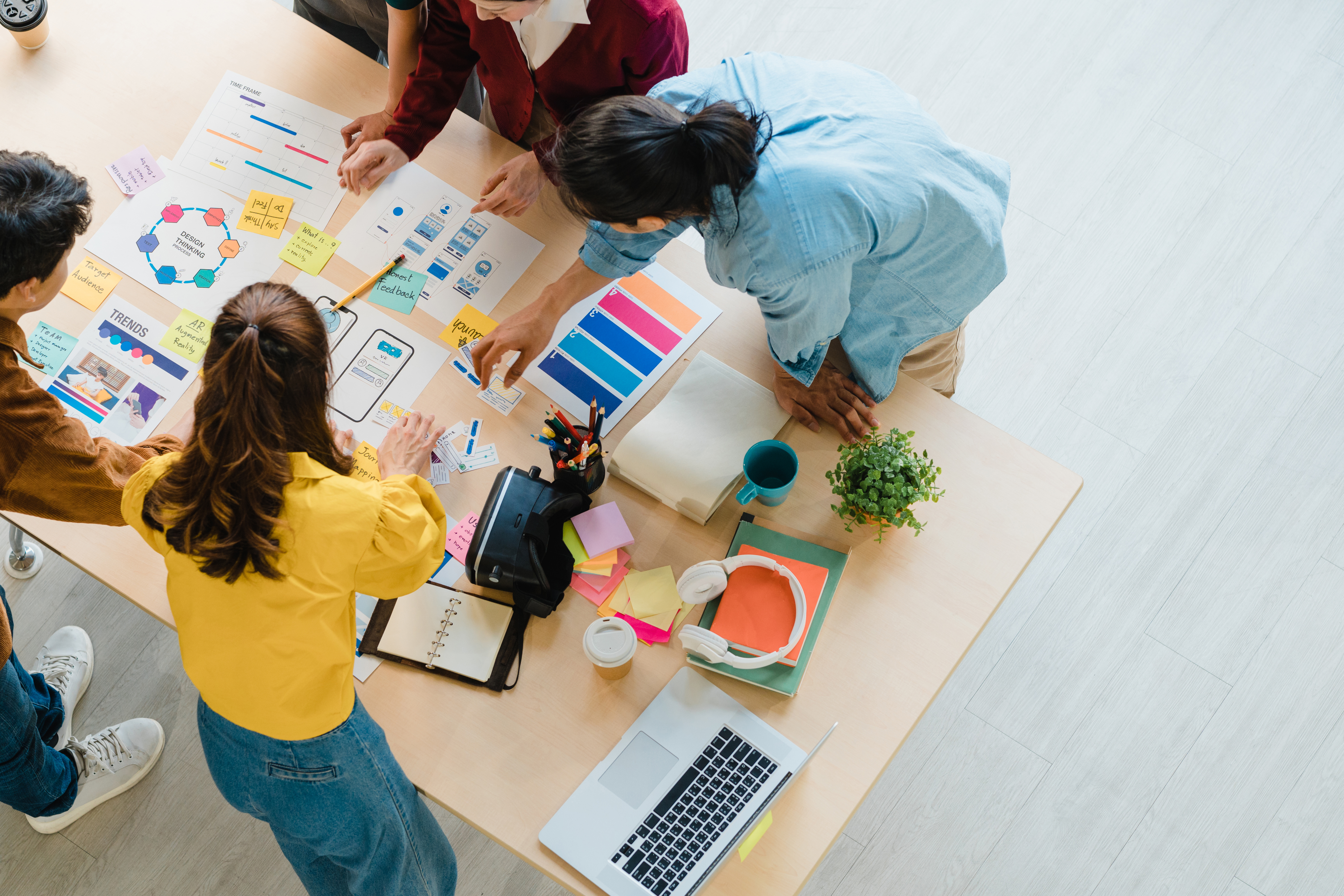 People work on creative engagement around a table