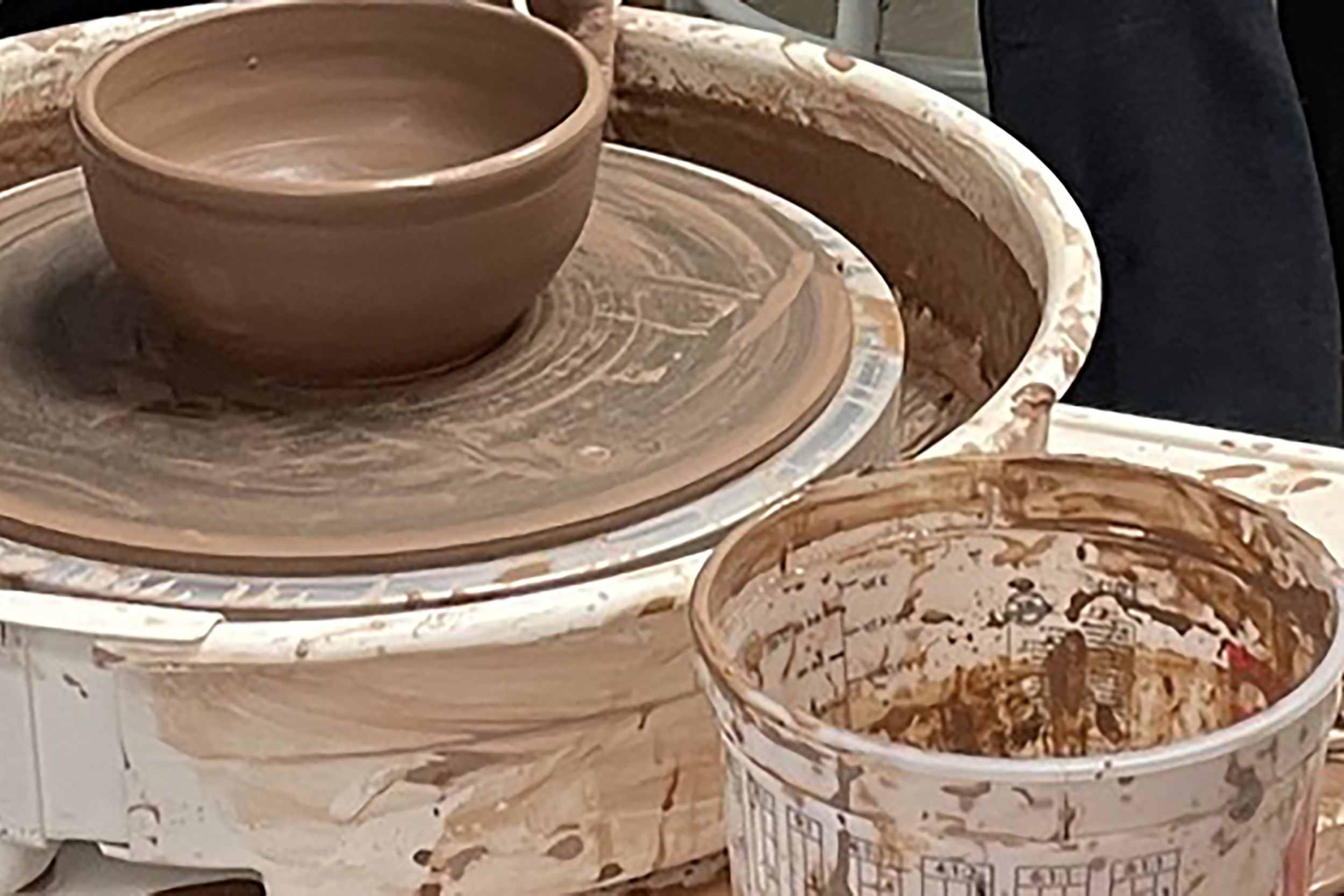 A clay bowl on a pottery wheel