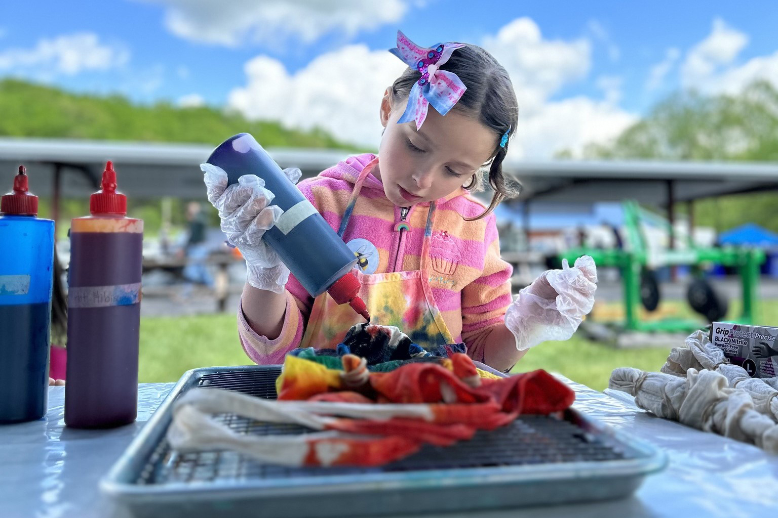 A girl tie-dyes a shirt