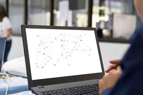 A person works on a laptop
