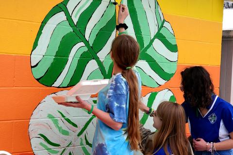 People paint the Dawson Springs West Camp Mural