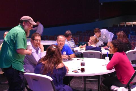 People talk at a downtown team series meeting