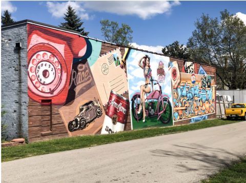 "UNTITLED" Artist: MrDheo and Pariz One Location: Located at 266 Jefferson Street, Lexington, Kentucky About the Mural: The mural is divided into several sections and features vintage oversized artwork in vibrant, eye-catching colors.